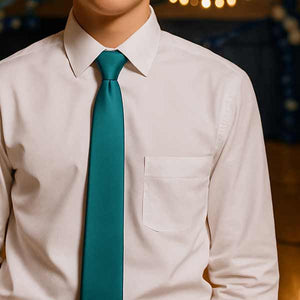 Teenage boy wearing a teal necktie with a white dress shirt in a decorated gym for a homecoming dance