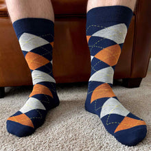 Load image into Gallery viewer, Man wearing a pair of navy blue and burnt orange argyle socks